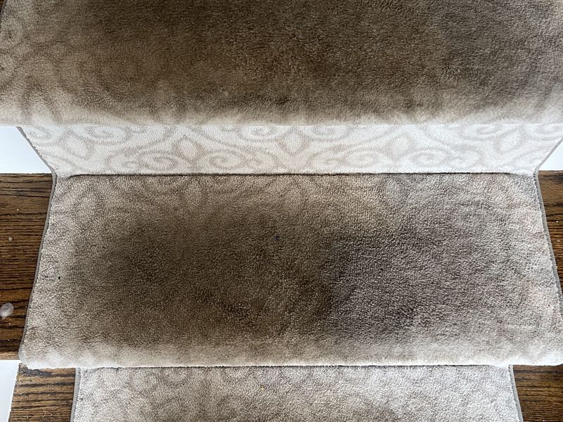 Scroll-pattern stair runner before cleaning by Dr. Carpet18, dark worn treads